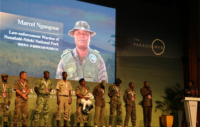 Marcel Ngangoue (standing to the left of the podium), Head of Conservation of Biodiversity and Law enforcement at Nouabale-Ndoki National Park stands with other rangers 